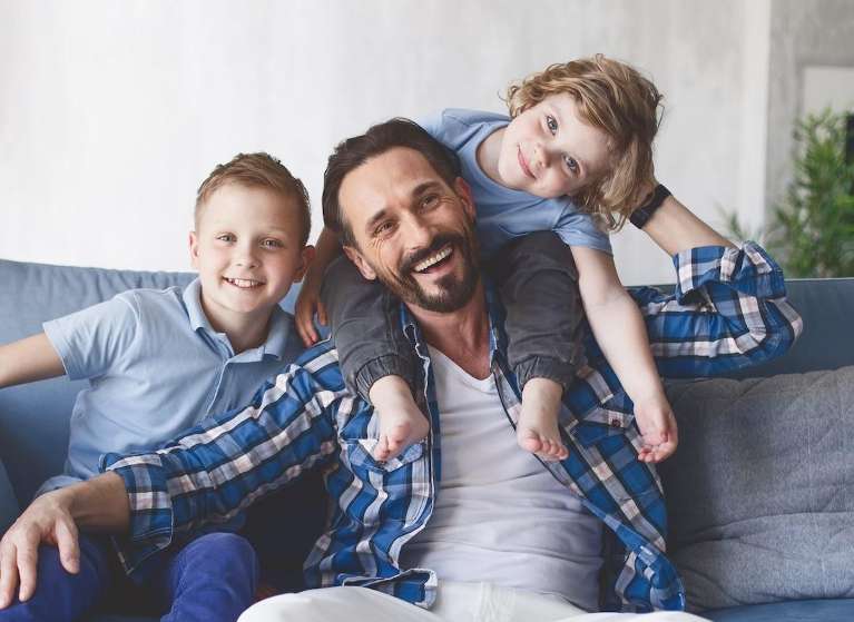 Dad with two young kids smiling together, foothill ranch ca