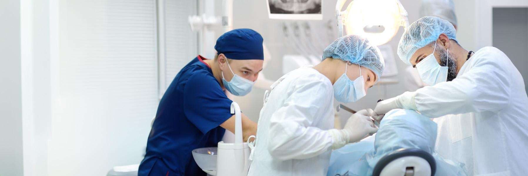 A group of dentist gathered addressing dental emergency