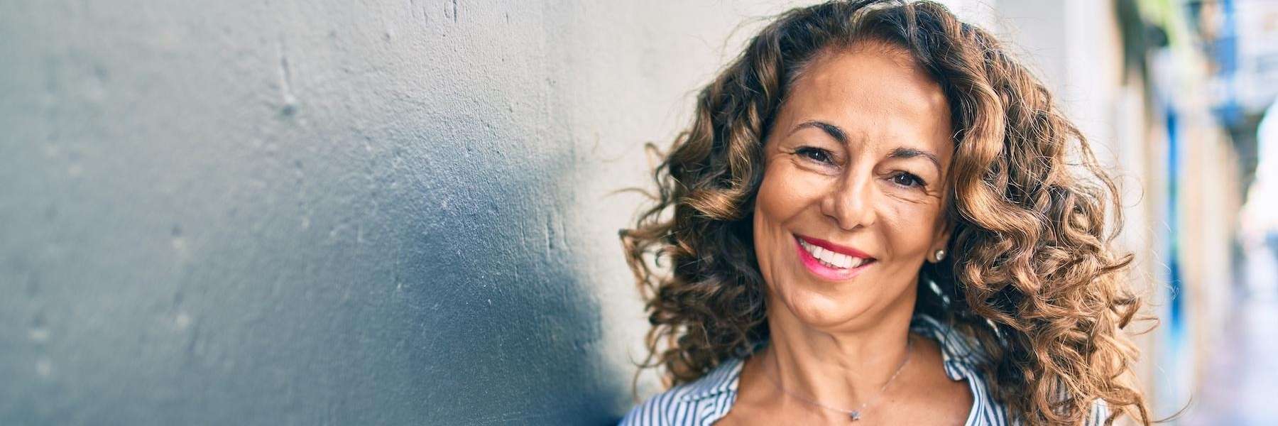 Patient smiling with denture implants in Foothill Ranch, CA